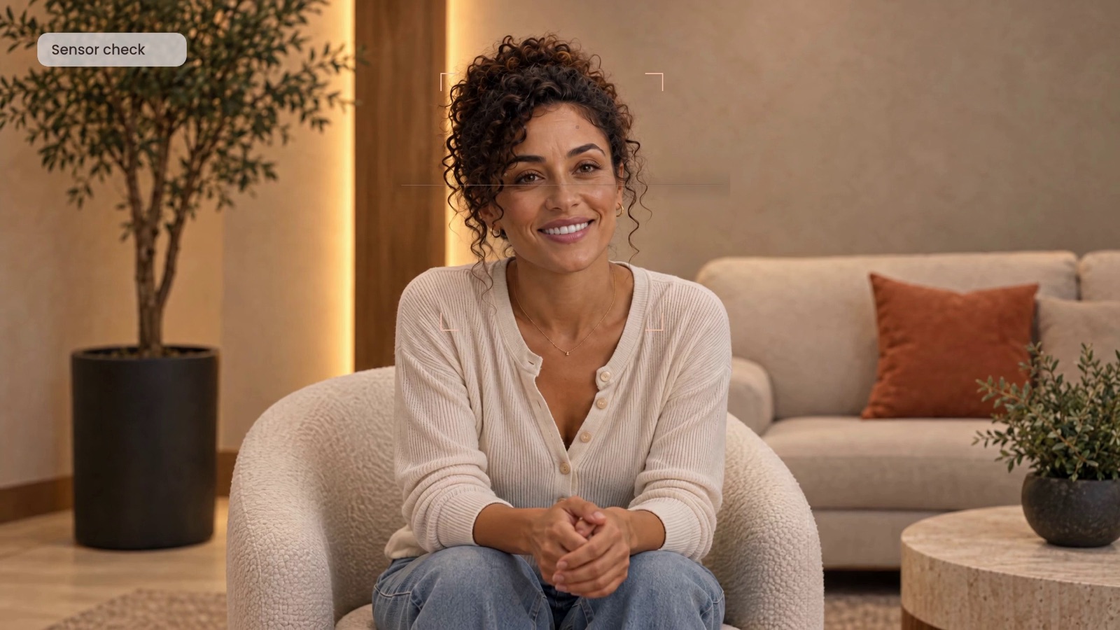 YOUNITY, Meet REVO: a woman sits on a sofa in a warm consultation lounge, smiling mid-conversation